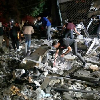 People work to clear debris after an airstrike that hit an apartment building in Beirut. Pic: AP Photo/Hussein Malla