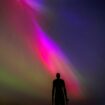 The aurora borealis, also known as the northern lights, glow on the horizon at Another Place by Anthony Gormley, Crosby Beach, Liverpool , Merseyside . Picture date: Friday May 10, 2024. PA Photo. See PA story WEATHER Aurora. Photo credit should read: Peter Byrne/PA Wire