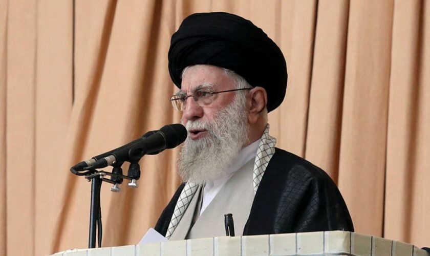 Iran's supreme leader holds rifle as he issues warning about possible future missile attack