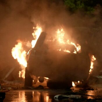 A vehicle is seen on fire at the site of an explosion that caused injures and destroyed vehicles at outside the Karachi airport, Pakistan, Sunday, Oct. 6, 2024. (AP Photo/Mohammad Farooq)