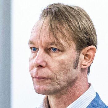 A man, who is a suspect in the disappearance of British toddler Madeleine McCann in Portugal, stands next to his lawyer Friedrich Fuelscher at his trial on unrelated sexual assault charges in Braunschweig, Germany, October 2, 2024. Christian B., is charged with three counts of aggravated rape and two counts of sexual abuse of children in Portugal between June 2007 and December 2000. Moritz Frankenberg/Pool via REUTERS