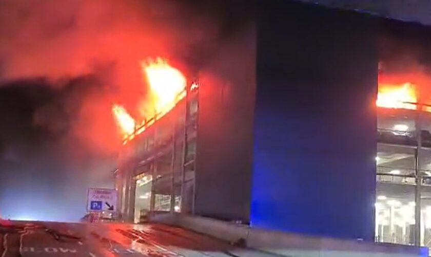 Handout screen grab from video issued by Bedfordshire Fire and Rescue Service a fire at a car park at Luton Airport On Tuesday. All flights at the airport have been suspended. Issue date: Wednesday October 11, 2023.