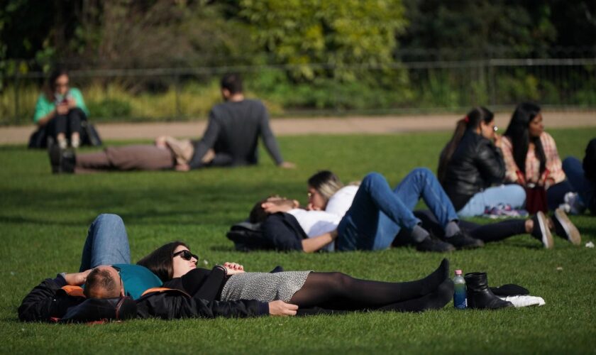 People enjoying the afternoon sun in St James's Park in London. Pic: PA