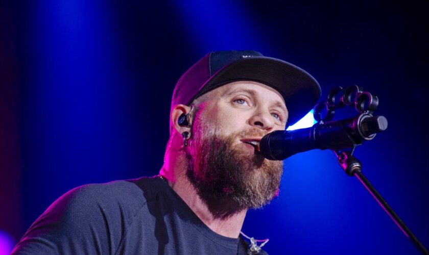 Country star Brantley Gilbert pauses concert as wife gives birth on tour bus – then returns to finish show