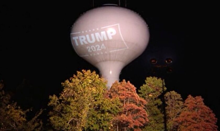 Resident fined $100 a day for projecting Trump sign on water tower