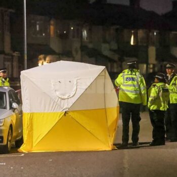 A crime scene tent erected in First Avenue, Dagenham, after a woman and two girls were stabbed. Pic: UKNIP