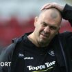 Leicester Tiger's Michael Cheika has his hand on his head while walking off the pitch