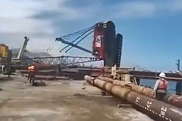 Dramatic moment worker avoids being crushed by escaping toppling crane in nick of time