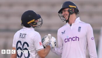 Zak Crawley and Joe Root clench gloves in the first Test against Pakistan