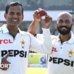 Pakistan spinners Noman Ali (left) and Sajid Khan (right) hold up the ball together as they walk off after dismissing England