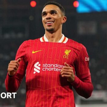 Trent Alexander-Arnold smiling while running on the pitch