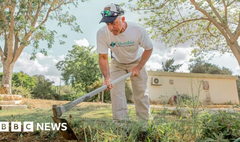 Keeping lawns neat in front of burned homes - a year on at kibbutz where Hamas killed 101