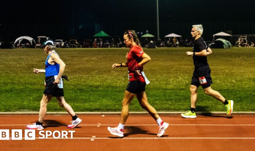 Competitors run through the night in the Sri Chinmoy 24hr Track Race in Battersea Park