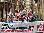 Moment hundreds of 'anti-tourist' activists storm the streets of Spain in protest amid wave of campaigning to try to keep holidaymakers away