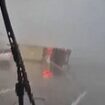 Most shocking moments from Spain's flood disaster caught on camera: Lorry is overturned in torrential downpour, woman is airlifted from deep water with her dog and bridge is swept away in apocalyptic scenes