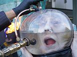 Ocean Rebellion stage harrowing protest showing sea goddess drowning in oil in a fishbowl helmet outside London Marine Environment Protection Committee meeting