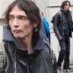 Rock star is completely unrecognisable with a short dark hair-do and a clean shaven face - but can YOU guess who it is?