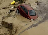 Terrifying moment cars are swept away as roads become rivers in Spain: Rescuers searching for missing people after cities were smashed with golf ball-sized hailstones