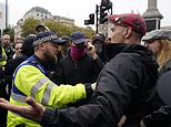 Tommy Robinson supporters chant 'We want Tommy out!' as their figurehead is held in a police cell - while police clash with protesters on both sides and violent demonstrators are arrested