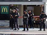 Woman is 'executed' during suspected terror attack in Israeli city as 10 others wounded in 'stabbing and shooting' at bus station