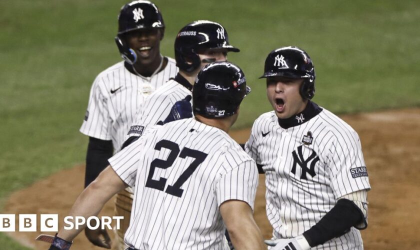 New York Yankees shortstop Anthony Volpe (right) celebrates after hitting a grand slam in game four