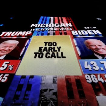 A giant screen shows a broadcast of the 2020 election in Michigan. Pic: Reuters