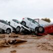 Vehicles marked by firefighters, with a code indicating that they have searched for casualties from the floods in Paiporta. Pic: Reuters