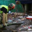 An emergency works on removing water from one of the exits of the car park. Pic: Reuters