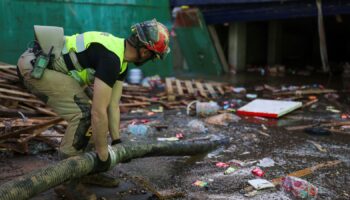 An emergency works on removing water from one of the exits of the car park. Pic: Reuters