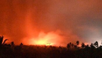 In this photo made available by Indonesia's Center for Volcanology and Geological Disaster Mitigation Agency (PVMBG) of the Ministry of Energy and Mineral Resources, the sky glows from the eruption of Mount Lewotobi Laki-Laki early Monday, Nov. 4, 2024, in East Flores, Indonesia. (PVMBG via AP)