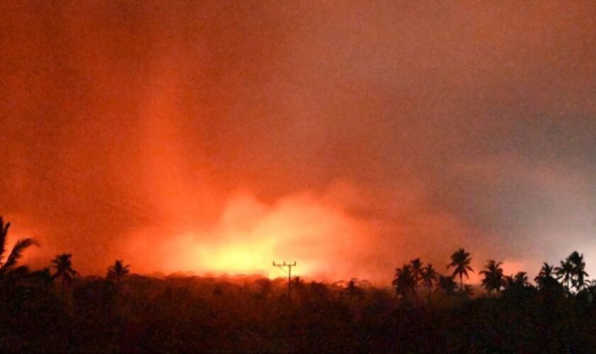 In this photo made available by Indonesia's Center for Volcanology and Geological Disaster Mitigation Agency (PVMBG) of the Ministry of Energy and Mineral Resources, the sky glows from the eruption of Mount Lewotobi Laki-Laki early Monday, Nov. 4, 2024, in East Flores, Indonesia. (PVMBG via AP)