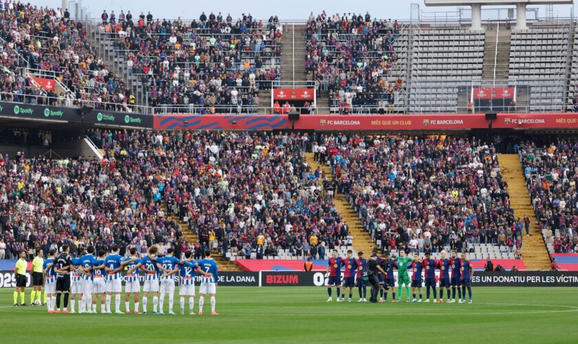 Players observe a minute's silence for the flood victims ahead of Barcelona v Espanyol on Sunday. Pic: AP