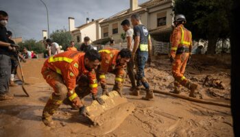 Spain deploys 15,000 police and troops to help flood relief – as vigilante protection groups patrol streets