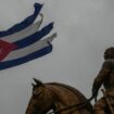 A Cuban flag shredded by the winds of Hurricane Rafael flies above the statue of General Calixto Garcia in Havana, Cuba Pic: AP