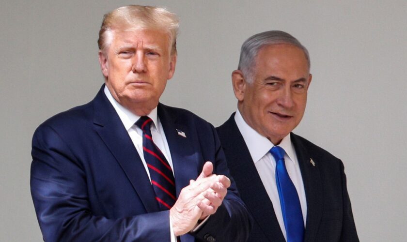 U.S. President Donald Trump applauds as he arrives with Israel's Prime Minister Benjamin Netanyahu prior to signing the Abraham Accords, normalizing relations between Israel and some of its Middle East neighbors in a strategic realignment of Middle Eastern countries against Iran, at the White House in Washington, U.S., September 15, 2020. REUTERS/Tom Brenner