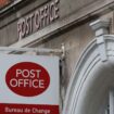 A post office sign hangs above a shop