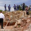 Police officers and private security personnel at the entrance to the mine in Stilfontein, South Africa. Pic: AP/Denis Farrell