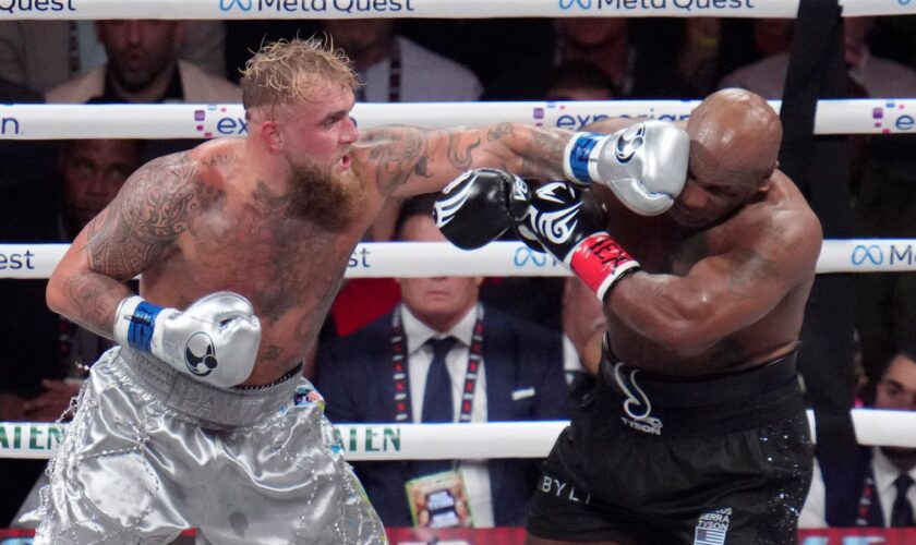 Jake Paul lands a left to Mike Tyson during their heavyweight boxing match, Friday, Nov. 15, 2024, in Arlington, Texas. (AP Photo/Julio Cortez)