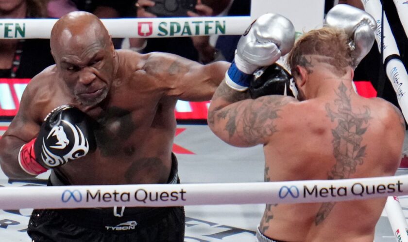 Mike Tyson lands a left to Jake Paul during their heavyweight boxing match, Friday, Nov. 15, 2024, in Arlington, Texas. (AP Photo/Julio Cortez)