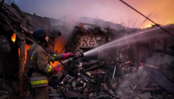 Un secouriste tente d'éteindre un incendie après une attaque de drone à Mykolaïv (Ukraine) le 17 novembre 2024