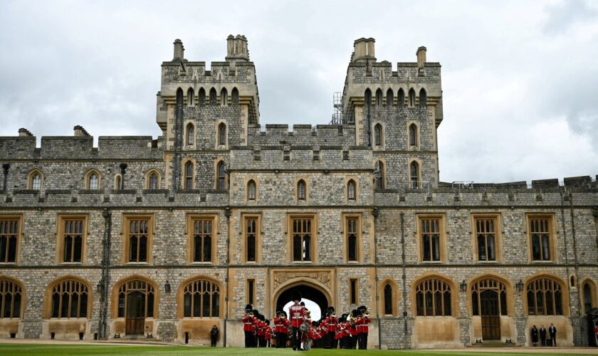 The Band of the Irish Guards, led by the Irish Guards' Regimental Mascot, an Irish wolfhound named Seamus (Turlough Mor), march into Windsor Castle's Quadrangle through the George IV Gate during a ceremony where Britain's King Charles III presents New Colours to No 9 and No 12 Company The Irish Guards at Windsor Castle, west of London, on June 10, 2024. The new Colours will be those trooped in the Trooping of the Colour at His Majesty's official Birthday Parade in London on Saturday June 15, 202