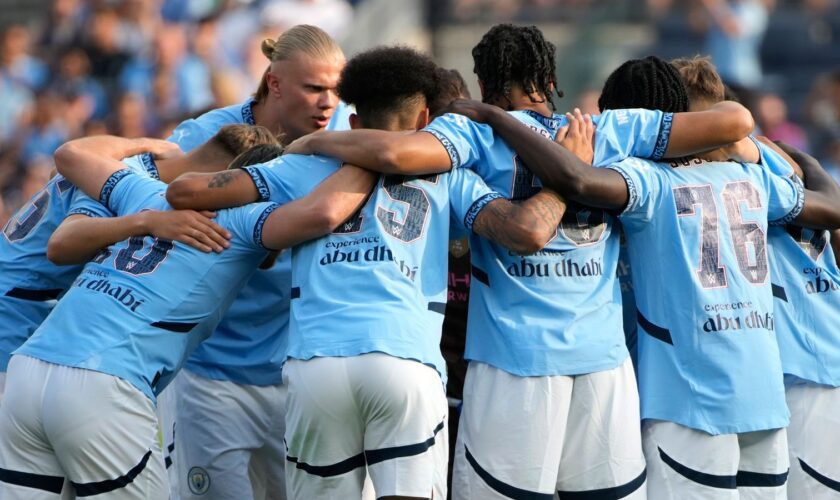 Manchester City FC players huddle up before a soccer game against AC Milan, Saturday, July 27, 2024, in New York. (AP Photo/Pamela Smith)