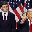 Barron Trump, 18, towers over his family as he celebrates his father's sensational return to the White House