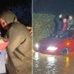 Bizarre moment boyfriend proposes to partner on roof of their car during flood