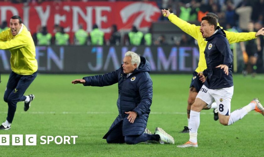 Fenerbahce boss Jose Mourinho tries to do a knee slide after his side's win at Trabzonspor