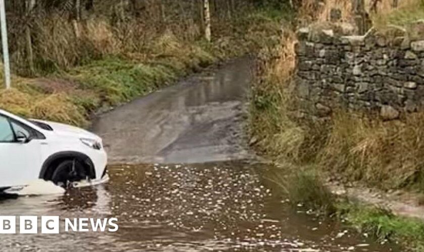 Man dies after car enters flooded ford