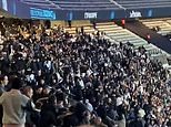 Moment violence breaks out during France's football match against Israel as fans seen brawling and others flee their seats after more than 6,000 police were deployed to 'high risk' game