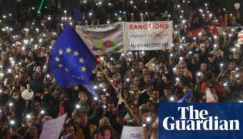 Protests in Georgia over disputed vote as PM threatens to ban opposition