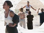 Tulisa makes a dramatic I'm A Celeb entrance as she parachutes from a helicopter onto Byron Bay beach to meet a beaming Coleen Rooney and their fellow campmates