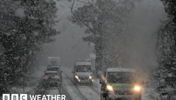 Vehicles navigate snowy conditions near Glenmore on the road to the Cairngorm ski area